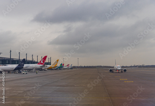 BERLIN, GERMANY - DECEMBER 12. 2022: Aircrafts from different companies docking at BER Airport photo