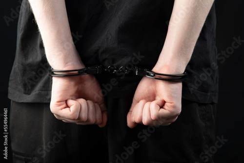 A man, a criminal in handcuffs.Criminal news.Detention of a criminal.