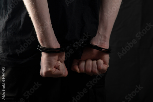 A man, a criminal in handcuffs.Criminal news.Detention of a criminal.