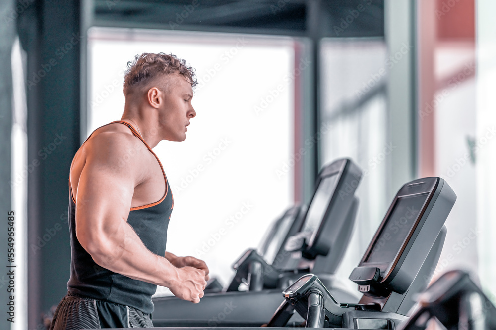 young athlete runs on a treadmill in the gym young athlete runs on a treadmill in the gym
