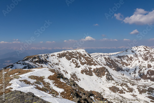 Scenic view of Kreiskogel seen from Scharfes Eck, Seetal Alps, Styria, Austria, Europe. Alpine pasture and ridges with background view of snowcapped peaks of Ennstaler Alps, Northern Limestone Alps photo