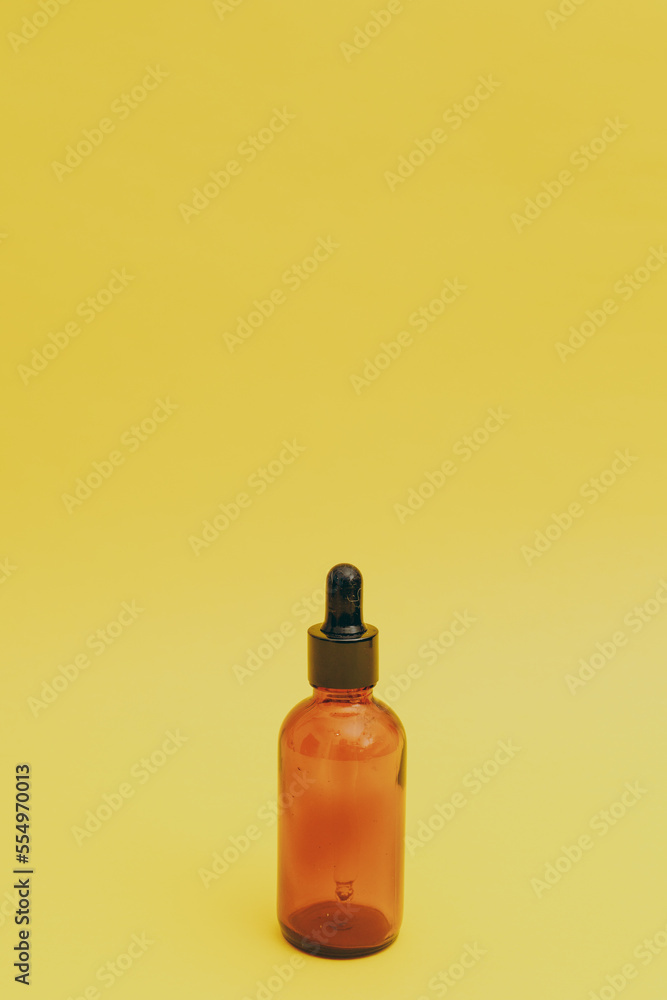 Serum bottle on yellow background