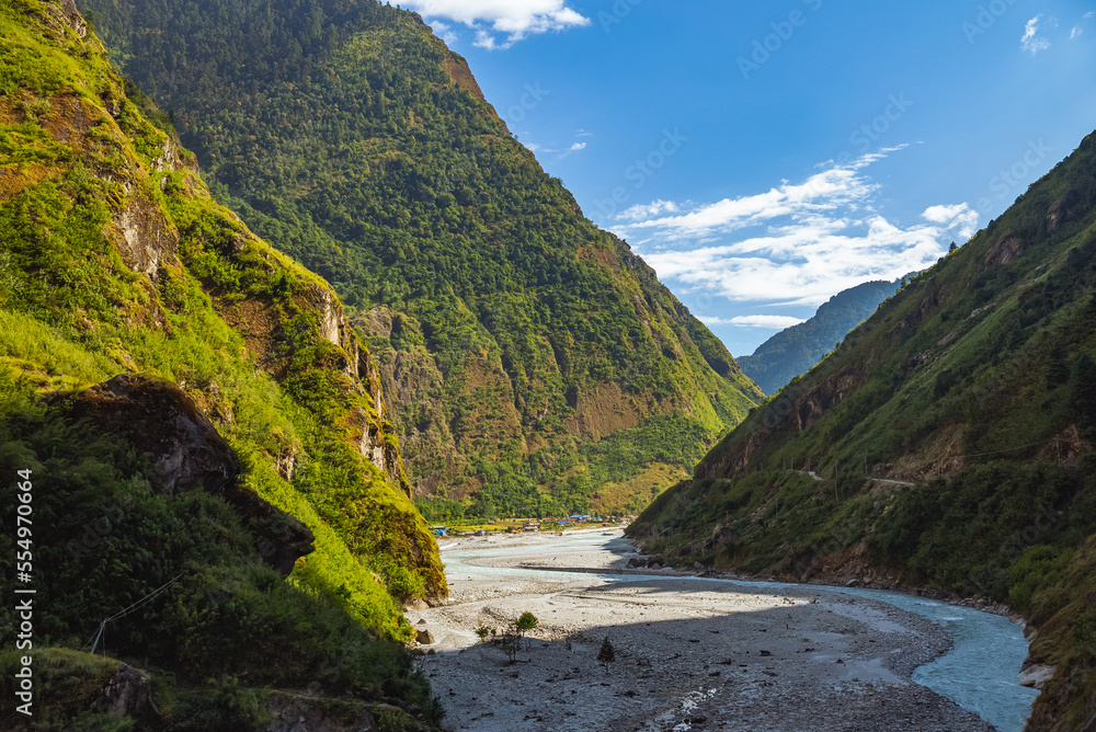 River and Valley along the Annapurna circuit trek path with the village of Tal in the distance, Nepal