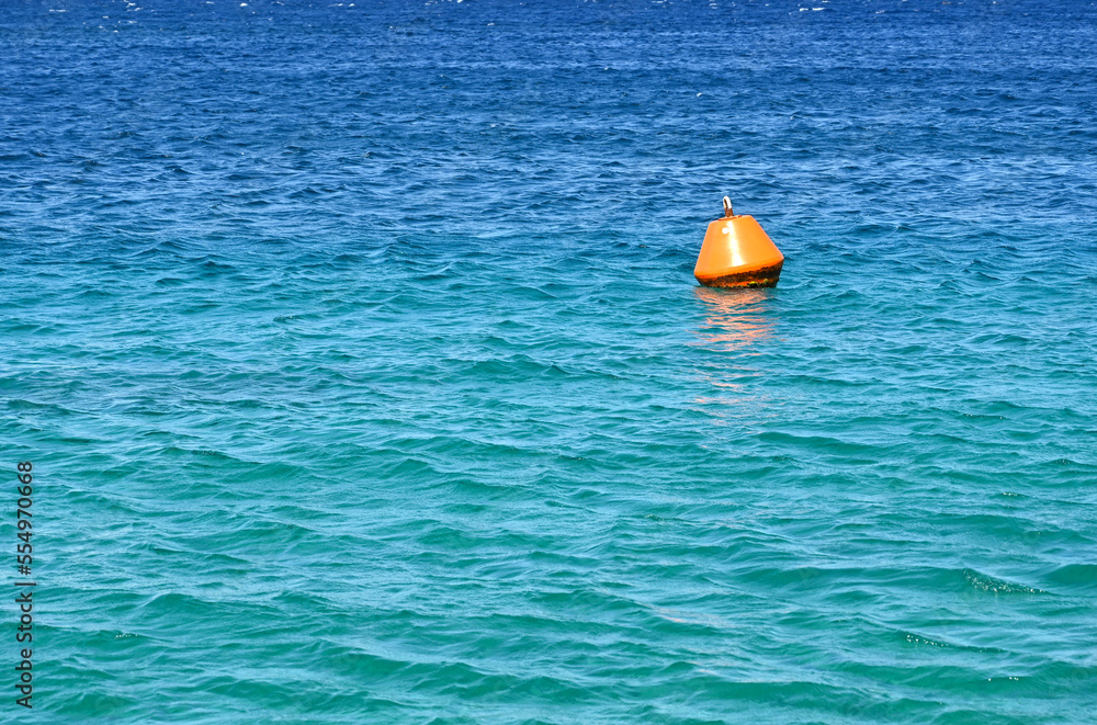 Orange buoy floating on the sea as a warning to ships. No people. Copy space. Orange buoy floating on the sea as a warning to ships. No people. Copy space.