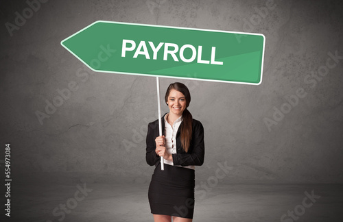 Obraz na płótnie Young business person in casual holding road sign w salonie