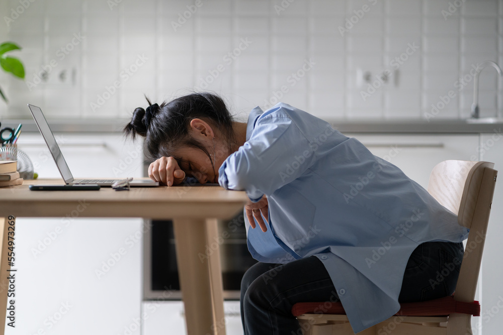 Tired Asian girl freelancer sleeping while working from home, lying on desk with laptop. Sleepy female student taking nap near computer while studying online. Distance learning and sleep deprivation Tired Asian girl freelancer sleeping while working from home, lying on desk with laptop. Sleepy female student taking nap near computer while studying online. Distance learning and sleep deprivation