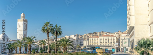 The old great mosque of Algiers. El Hadi Mghiref garden, busses parked at the Martyr's square bus station, El Aurassi hotel between two palm trees and a blue sky. photo