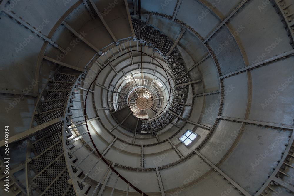 Iron spiral staircase inside the old lighthouse, bottom view