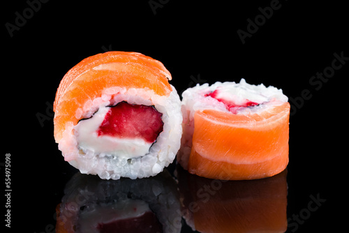 Japanese cuisine sushi rolls with tuna, salmon, cream cheese, rice and nori.