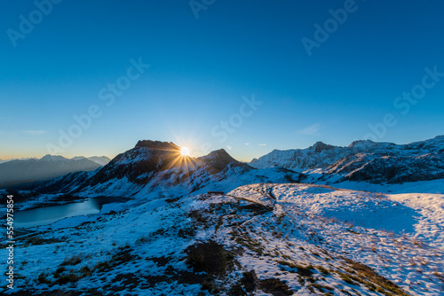 sunrise over the snowy mountains during spring (Tilisunasee, Tschagguns, Vorarlberg, Austria)