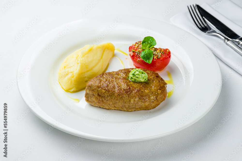 Homemade beef cutlets with potatoes on white plate Homemade beef cutlets with potatoes on white plate