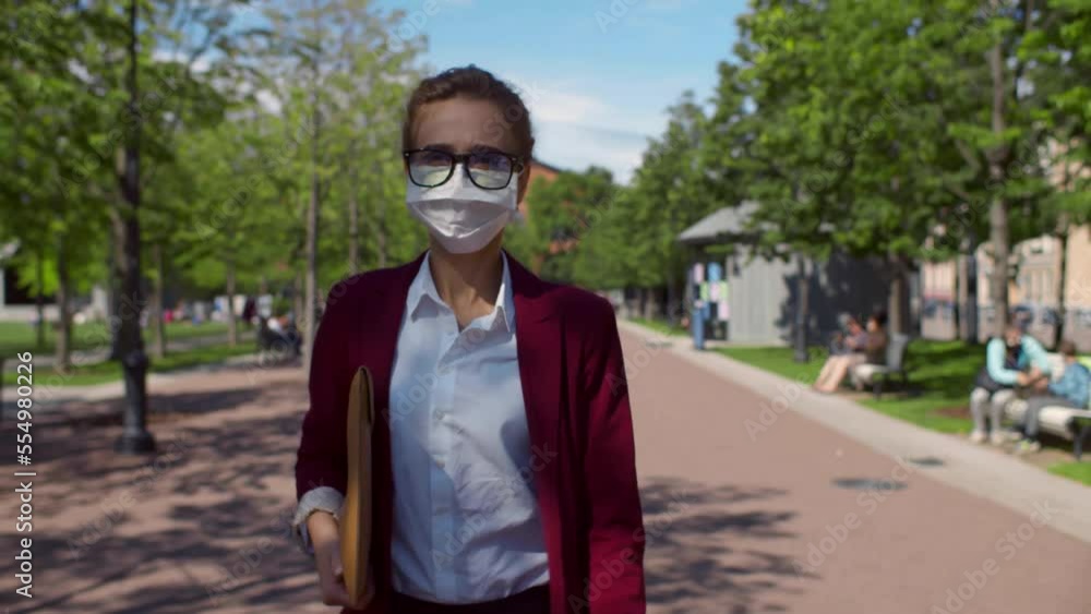 Young businesswoman walk outdoor with face mask while commuting. Realtime Young businesswoman walk outdoor with face mask while commuting. Realtime
