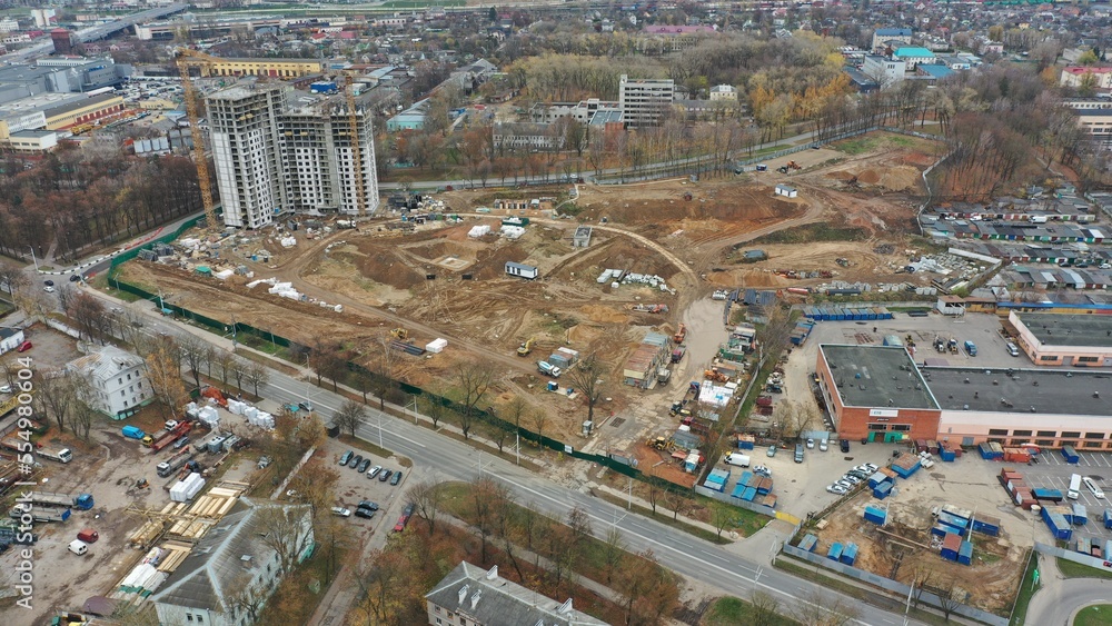 Panoramic view of a multi-storey residential building in Minsk in autumn. Construction of a new residential complex. Construction of a new neighborhood. Autumn at the construction site.