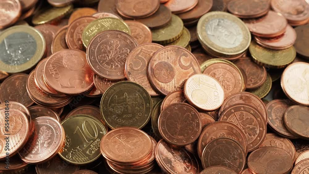 Close-up of rotating metal coins. Rotating pile of euro cents.