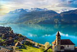 beautiful idylic nature scenery of lake Brienz with turquoise waters. Switzerland, Bern canton. Aerial view with little church in the morning light