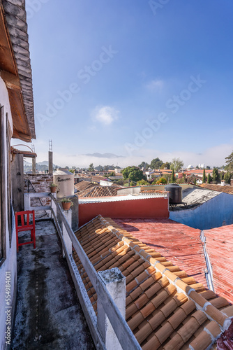 Beautiful sunny day in mountain city in Mexico. The famous tiled roofs of the city.