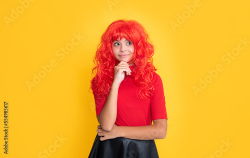 smiling girl with red long hair on yellow background