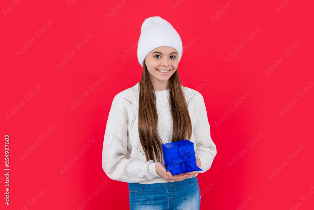 christmas holiday. glad teen girl with christmas present in studio. teen girl christmas holiday. glad teen girl with christmas present in studio. teen girl