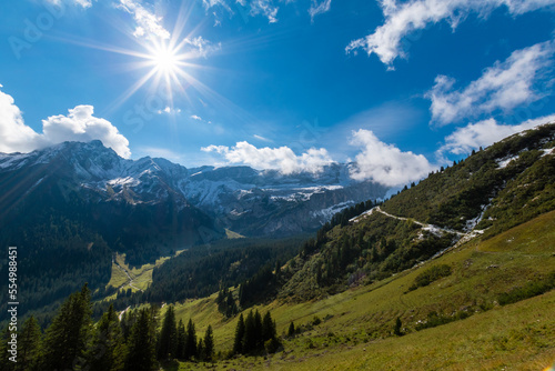 hiking path along the mountain slope during sunshine (Vorarlberg, Austria)