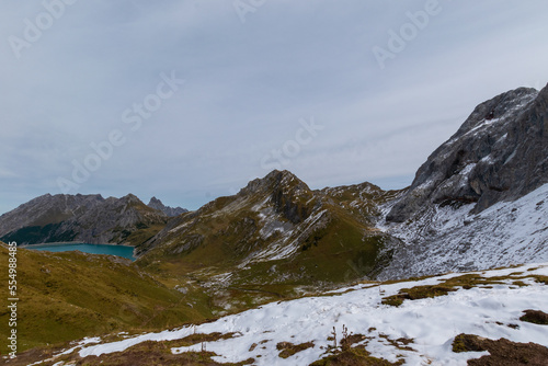 Lünersee in the Austrian Alps with snowy slopes