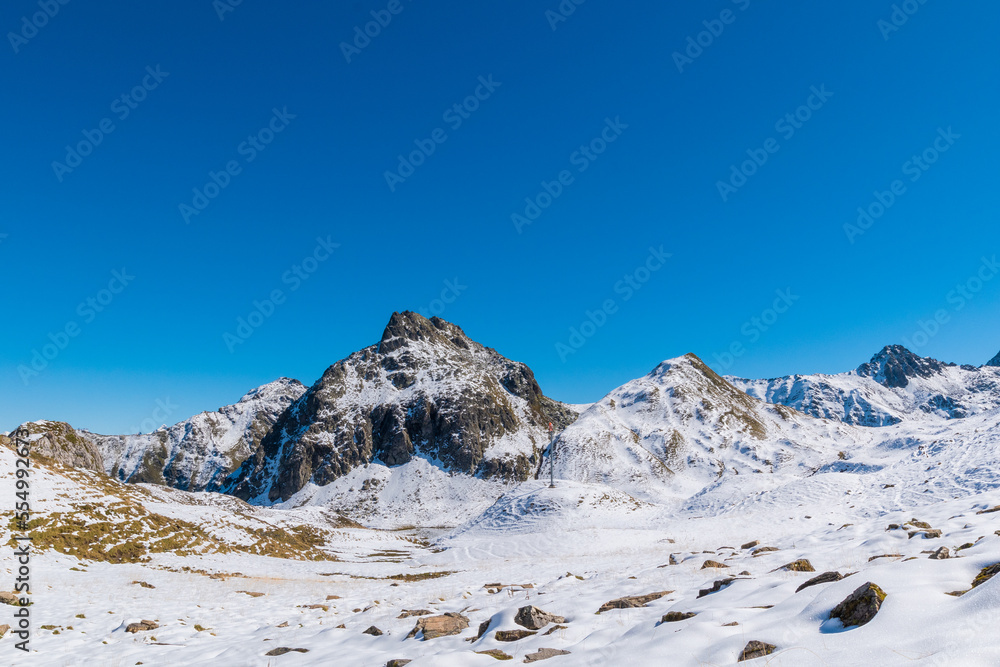 An alpine landscape covered in snow on a sunny day during summer (Vorarlberg, Austria)