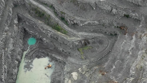 Aerial view of deep granite quarry, heavy industry