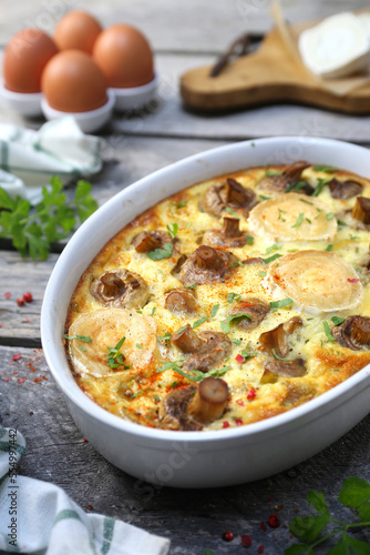Vegetable mushroom clafoutis ( flan ) with leeks and goat cheese in ceramic bakeware