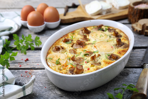 Vegetable mushroom clafoutis ( flan ) with leeks and goat cheese in ceramic bakeware