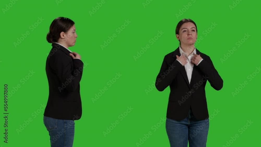 Close up of optimistic woman posing over greenscreen in studio, wearing office suit on camera. Female model working as corporate employee, standing on background acting confident. Close up of optimistic woman posing over greenscreen in studio, wearing office suit on camera. Female model working as corporate employee, standing on background acting confident.