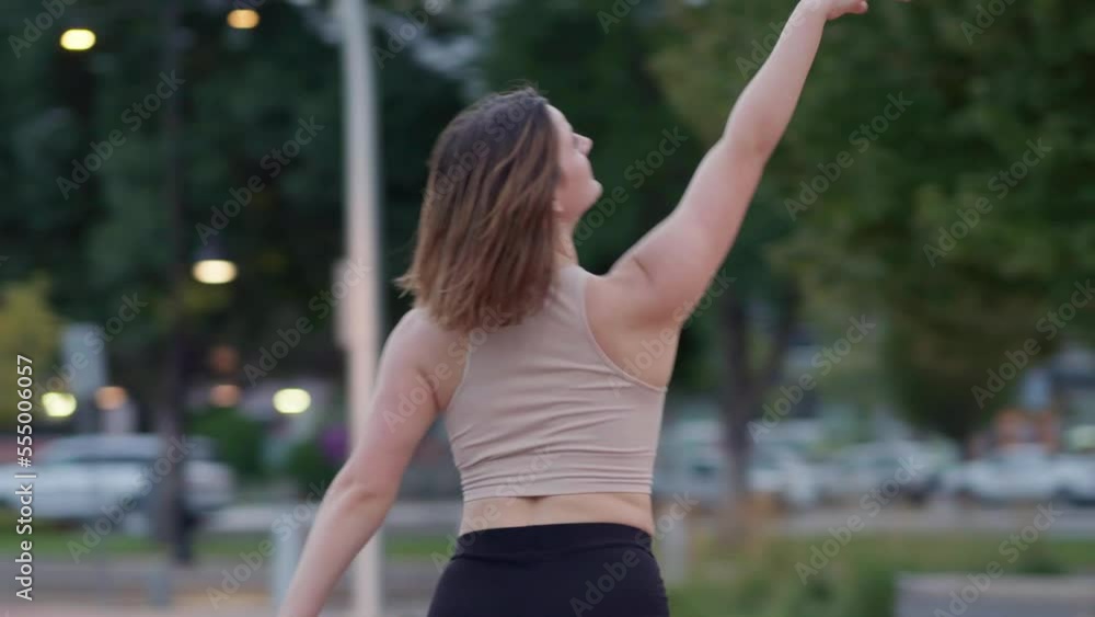 Young woman expressively dancing outside Young woman expressively dancing outside