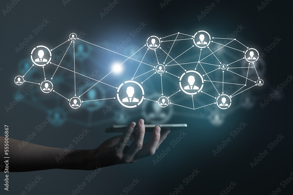 Human resources manager pointing at virtual network chain with person icons. Human capital and teambuilding concept. Human resources manager pointing at virtual network chain with person icons. Human capital and teambuilding concept.