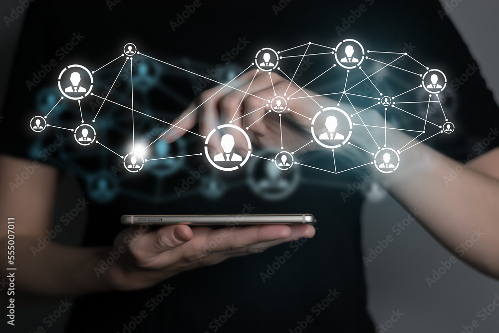 Human resources manager pointing at virtual network chain with person icons. Human capital and teambuilding concept. Human resources manager pointing at virtual network chain with person icons. Human capital and teambuilding concept.