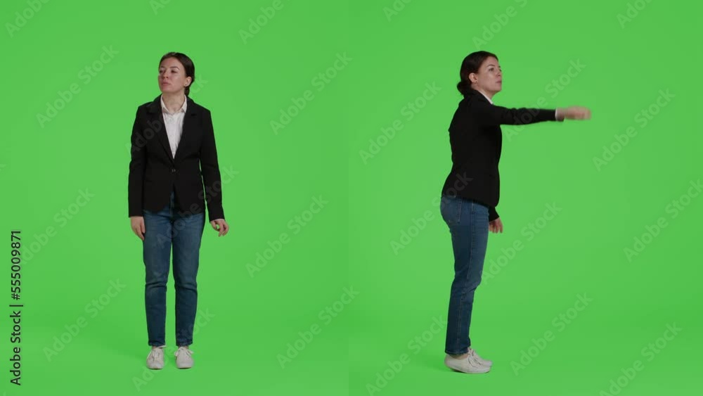Corporate employee expressing wave to call someone over, asking for person to come in studio. Female manager in suit raising hand standing over full body isolated greenscreen background. Corporate employee expressing wave to call someone over, asking for person to come in studio. Female manager in suit raising hand standing over full body isolated greenscreen background.