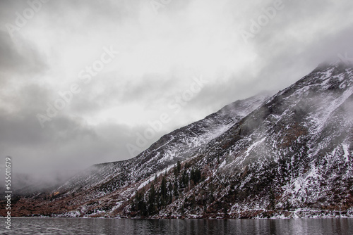 snow covered mountain with fog