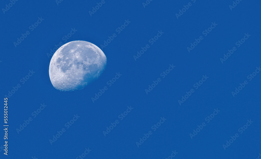 A growing moon photographed in the morning sky. Many areas of the lunar surface are visible, such as craters, highlands. A growing moon photographed in the morning sky. Many areas of the lunar surface are visible, such as craters, highlands.