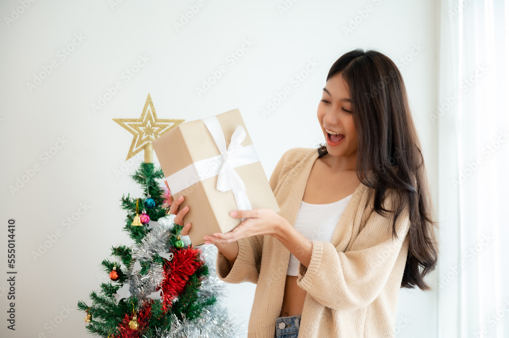 Young asian woman happy and smile while opening gift box. Happy new year, Thanksgiving, Merry Christmas Young asian woman happy and smile while opening gift box. Happy new year, Thanksgiving, Merry Christmas