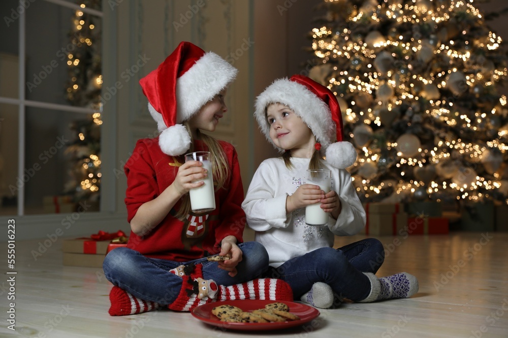 Cute little children with milk and cookies at home. Christmas time Cute little children with milk and cookies at home. Christmas time