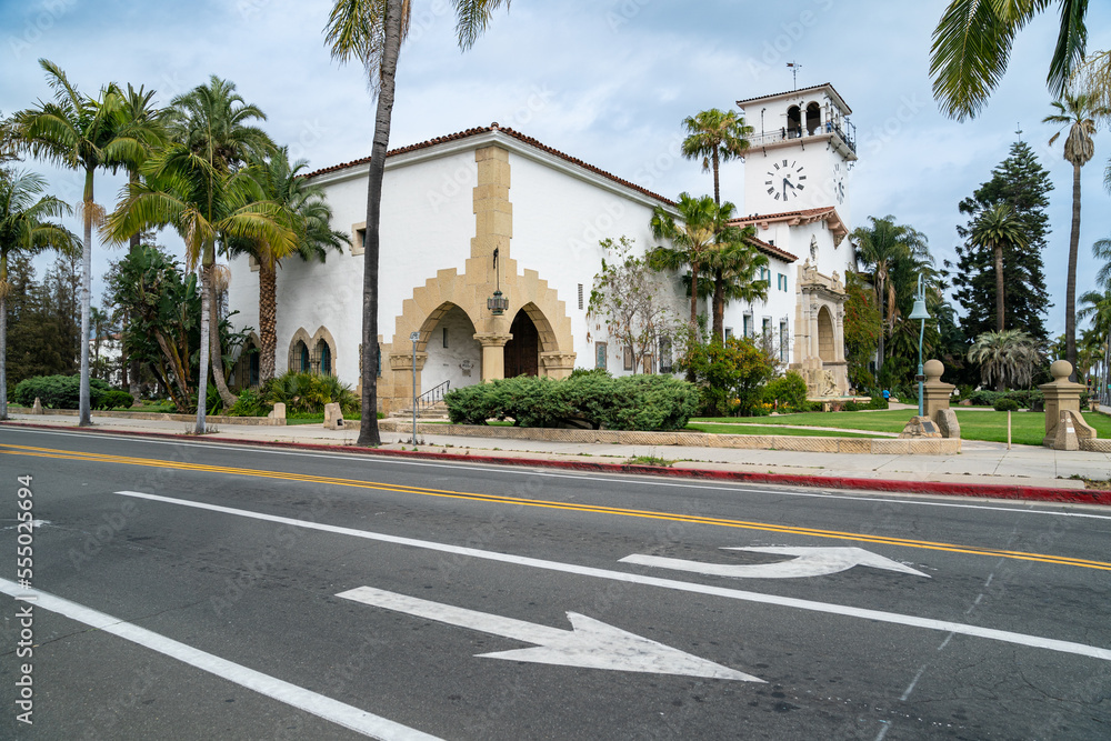 California, USA - May 20, 2018: Superior Court of California, County of Santa Barbara with its famous clock tower and the palm tree lined main street on sunny day