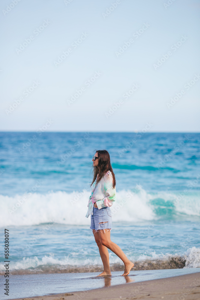 Young happy woman on the beach