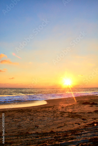 sunset with sun in the horizont and sunshines in the sand, barra de coyuca in acapulco guerrero  photo