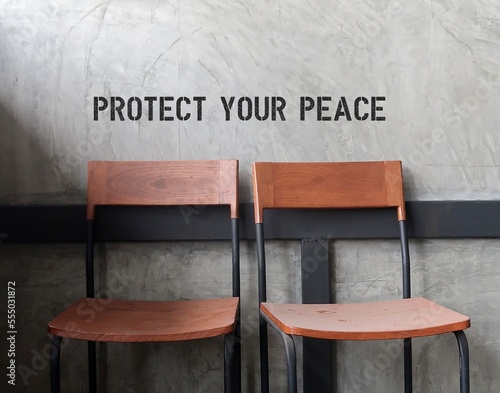 Canvastavla Two vintage chairs with text on wall PROTECT YOUR PEACE, concept of to care and