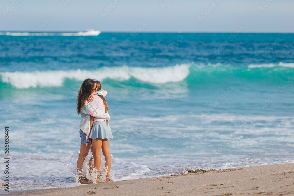 Adorable little girl and young mother on tropical white beach Adorable little girl and young mother on tropical white beach