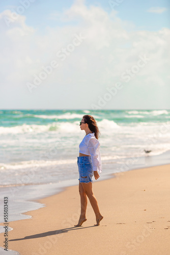 Young happy woman walking on the beach  © travnikovstudio