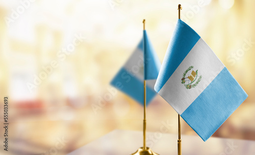 Small flags of the Guatemala on an abstract blurry background