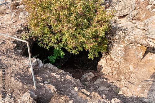 The entrance  to the cave where the primitive people lived in Tel Yodfat National park, in northern Israel photo