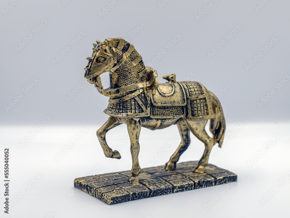 A small bronze statuette of a horse with a saddle