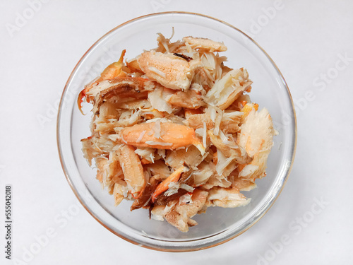 Top view of pile of fresh steamed crab meat in a bowl isolated on white background. Steamed crab meat ready to eat. Crab meat.