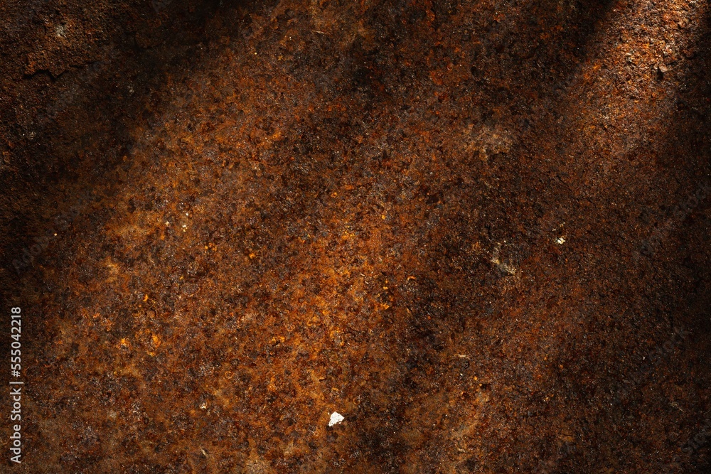 Rusty metal plate- corrosion on a dark red background. Abstract rust texture Rusty metal plate- corrosion on a dark red background. Abstract rust texture
