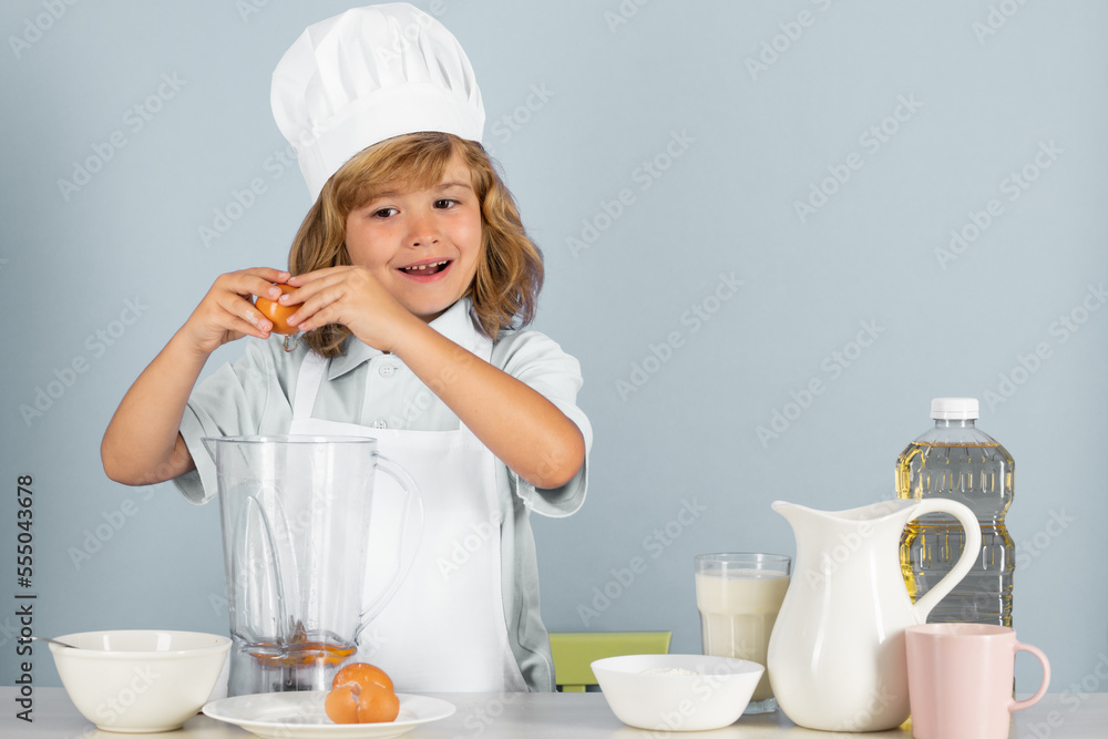 Child chef isolated on blue. Funny little kid chef cook wearing uniform cook cap and apron cooked food in the kitchen. Child chef isolated on blue. Funny little kid chef cook wearing uniform cook cap and apron cooked food in the kitchen.