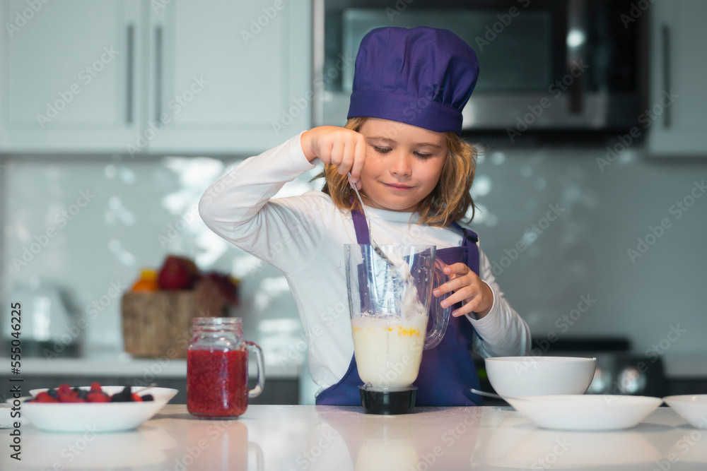 Kid in chef hat and apron. Chef child cook baking on the kitchen. Kid in chef hat and apron. Chef child cook baking on the kitchen.